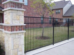 Wrought Iron Fence with Stone Columns