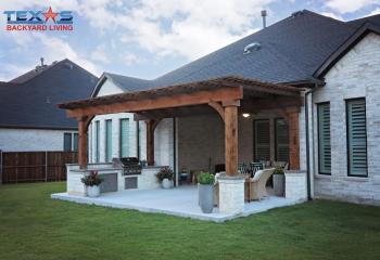 Pergola with Stone Columns on Gray Broom Concrete in Prosper, TX