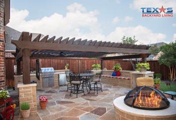 Pergola with Stone Seat Wall and Outdoor Kitchen in Celina, TX