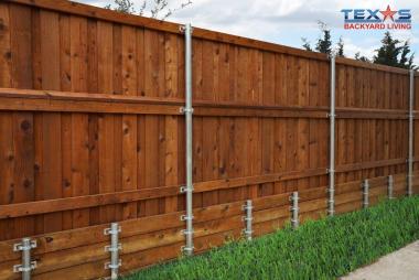 Fence retaining wall