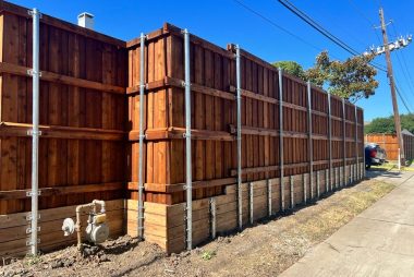Fence retaining wall