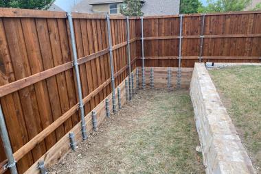 Fence retaining wall