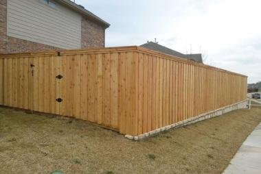 Board on Board Cedar Fence with Stone Retaining Wall in Plano, TX
