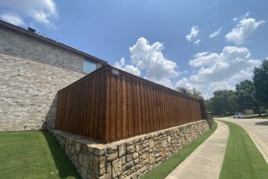 Pre-Stained Board on Board Fence and Stone Retaining Wall in  Flower Mound, TX