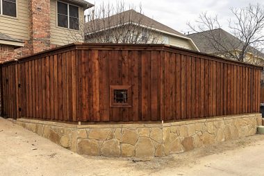 Pre-Stained Board on Board Fence with Stone Retaining Wall in Plano, TX