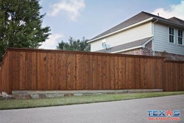 Board on Board Cedar Fence with Stone Retaining Wall in Plano, TX